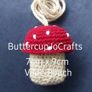 May include: A crocheted mushroom-shaped vape pouch with a red top and white dots, and a beige bottom. The pouch is 7cm by 9cm and has a beige cord.