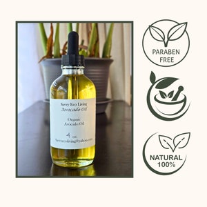 May include: A clear glass bottle of Savvy Eco Living Avocado Oil with a black dropper. The label reads "Organic Avocado Oil" and "4 oz." The image also includes "Paraben Free" and "Natural 100%" logos.