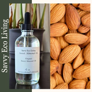 May include: A clear glass bottle with a dropper top filled with organic sweet almond oil. The bottle label reads "Savvy Eco Living Sweet Almond Oil" and "Organic Sweet Almond Oil". The label also includes the text "4 oz." and "Savvyecoliving@yahoo.com". The bottle is sitting on a wooden surface with a background of almonds.
