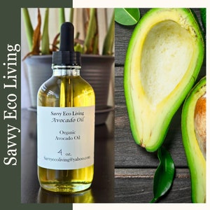 May include: A clear glass bottle of avocado oil with a black dropper, labeled "Savvy Eco Living Avocado Oil, Organic Avocado Oil, 4 oz." Next to it, a halved avocado on a wooden surface. The background features a potted plant.