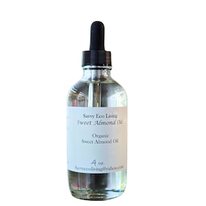 May include: A clear glass bottle with a black dropper top. The bottle is labeled "Savvy Eco Living Sweet Almond Oil" and "Organic Sweet Almond Oil". The bottle contains 4 ounces of oil.