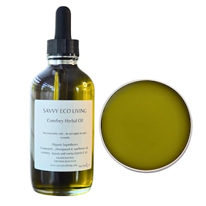 May include: A glass bottle of Savvy Eco Living Comfrey Herbal Oil with a dropper. The bottle is labeled with the product name, ingredients, and instructions for use. The bottle is next to a small, round, green jar of the same product.