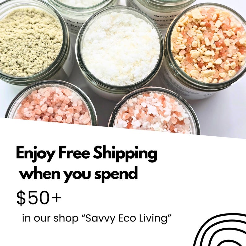 May include: Five glass jars filled with various bath salts and minerals. One jar contains a fine light green powder, another a white powder, and three jars contain coarse pink and white salt crystals. The jars have clear glass walls.