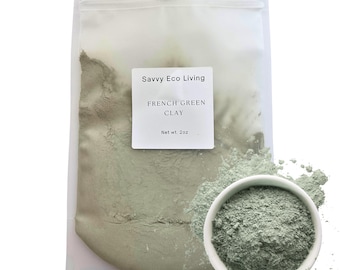 May include: A clear plastic pouch containing light green French Green Clay powder with a white label reading Savvy Eco Living, FRENCH GREEN CLAY, Net wt. 2oz. A small white bowl filled with the same fine green powder sits in the foreground.