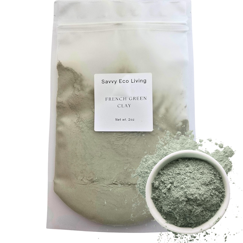 May include: A clear plastic pouch containing light green French Green Clay powder with a white label reading Savvy Eco Living, FRENCH GREEN CLAY, Net wt. 2oz. A small white bowl filled with the same fine green powder sits in the foreground.