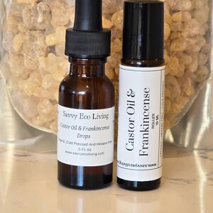 May include: Two bottles of castor oil and frankincense essential oil blend. One bottle is a 5-ounce dropper bottle labeled "Savvy Eco Living Castor Oil & Frankincense Drops". The other bottle is a 10 ml roller bottle labeled "Castor Oil & Frankincense Roller".