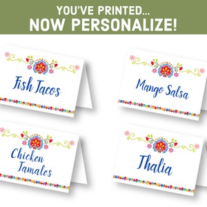 May include: Four printable place cards with a colorful floral design and text in blue. The cards read "Fish Tacos", "Mango Salsa", "Chicken Tamales", and "Thalia".