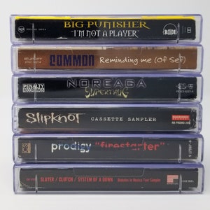 May include: A stack of six cassette tapes, including Big Punisher "I'm Not A Player", Common "Reminding Me (Of Self)", Noreaga "Superthug", Slipknot "Cassette Sampler", Prodigy "Firestarter", and Slayer/Clutch/System Of A Down "Diabolus In Musica Tour Sampler".