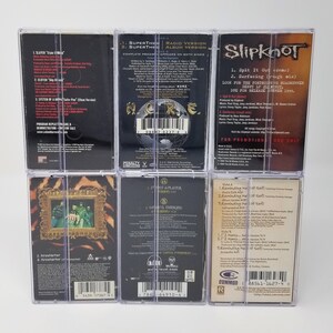 May include: Six clear plastic cases containing cassette tapes of various rock bands. The bands include Slayer, Superthe, Slipknot,  I-iot Aplater, and a band with the text "Reminding Me of Sef".