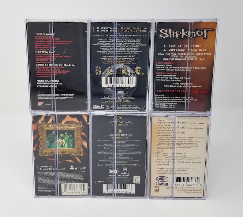 May include: Six clear plastic cases containing cassette tapes of various rock bands. The bands include Slayer, Superthe, Slipknot,  I-iot Aplater, and a band with the text "Reminding Me of Sef".
