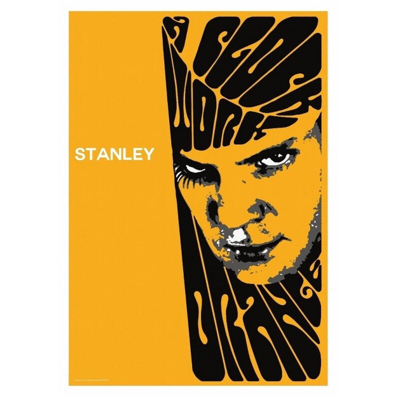 May include: A poster with a yellow background featuring a stylized portrait of a person with intense eyes. The word "STANLEY" is printed in white. Black text in a swirling font reads "SEE WORK".