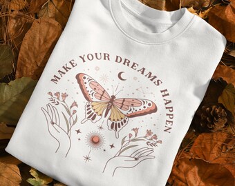 May include: White sweatshirt with a butterfly graphic and the text "Make Your Dreams Happen".