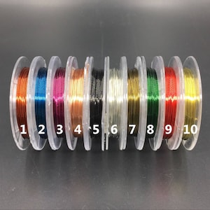 May include: Ten spools of wire in different colors, numbered 1 through 10. The colors are copper, blue, pink, gold, black, silver, gold, green, red, and gold.