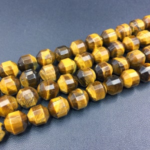 May include: A strand of faceted tiger's eye beads in shades of gold and brown. The beads are strung together to create a necklace or bracelet.