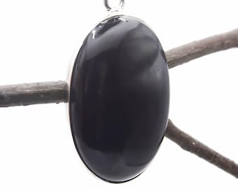 May include: A smooth, polished, oval-shaped black gemstone pendant set in a simple silver-toned metal frame. The pendant features a reflective surface and includes a small silver-toned metal bail at the top for attachment to a chain or cord.