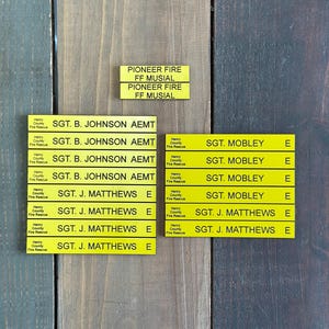 May include: Yellow name tags with black text. The tags read "SGT. B. JOHNSON AEMT", "SGT. J. MATTHEWS E", and "SGT. MOBLEY E".