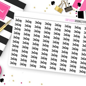 May include: A sheet of planner stickers with the word "Today" in a handwritten font. The stickers are black and white, with a dotted line separating the stickers. The image also includes a pink journal, a gold pen, and other stationery.
