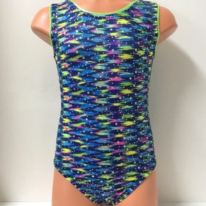 May include: A sleeveless leotard with a blue, green, and pink abstract print with white stars. The leotard has a lime green trim around the neckline and armholes.