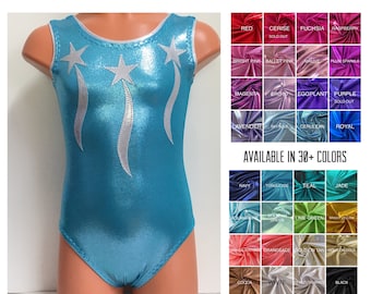 May include: A sleeveless leotard in a metallic sky blue fabric featuring three silver star appliques with trailing ribbons on the front. The garment has a round neckline with silver trim. A color chart displays over thirty fabric options.