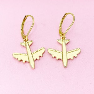 May include: Gold airplane earrings with a simple design. The earrings are dangle style with a hook closure.