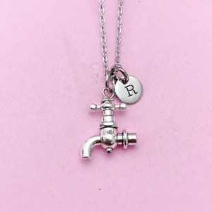 May include: Silver necklace with a faucet charm and a small round charm with the letter R.