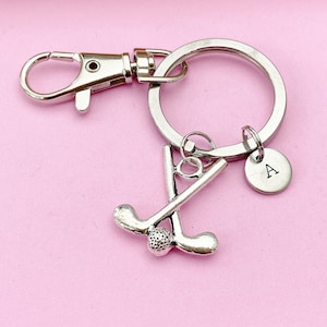 May include: Silver golf club keychain with a golf ball charm and a silver initial charm with the letter "A".