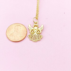 May include: A gold angel pendant necklace with a delicate chain. The pendant is about the size of a US penny.