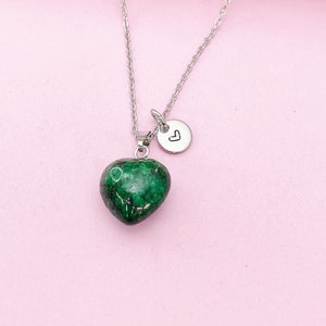 May include: A silver chain necklace with a green heart-shaped pendant and a small silver charm with a heart engraved on it.