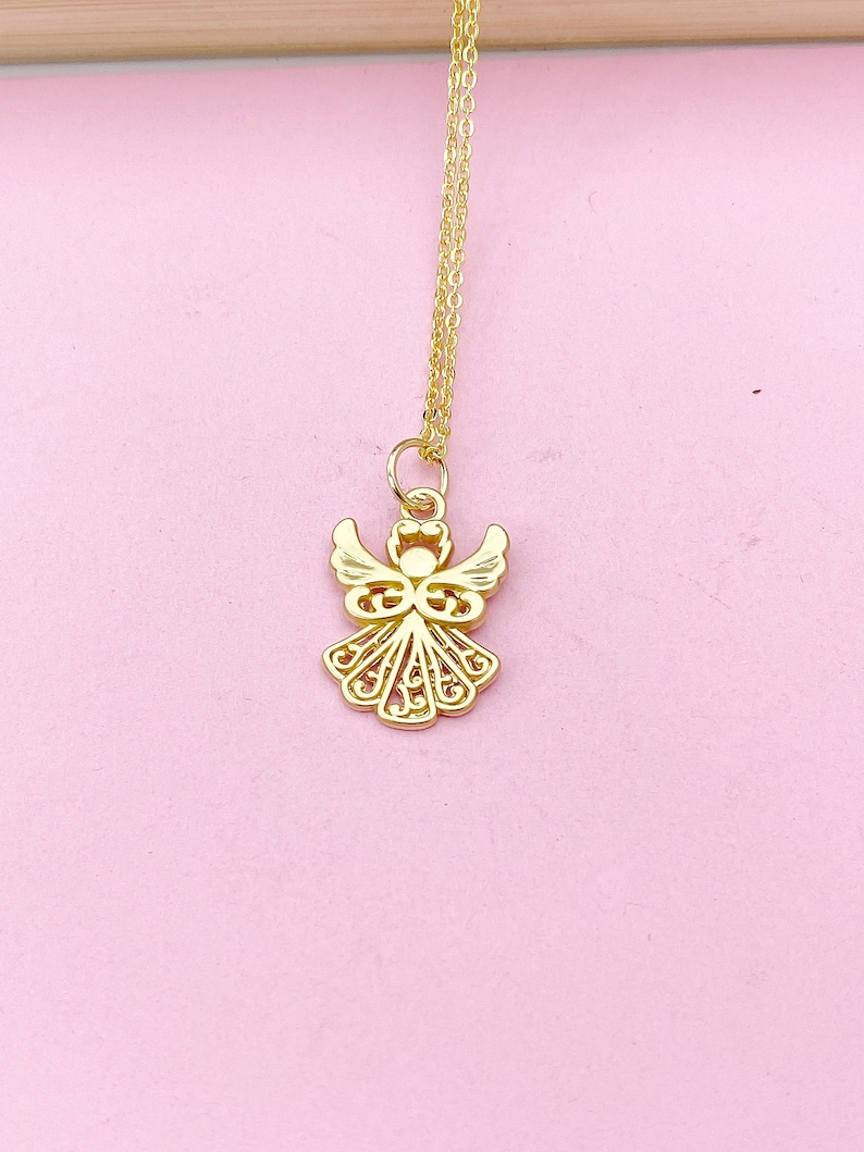 May include: A gold chain necklace with a delicate angel pendant. The angel is made of filigree metal and has a detailed design.