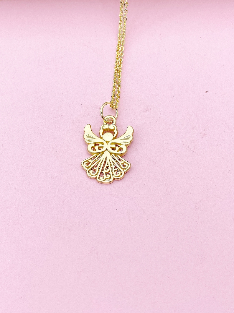 May include: A gold angel pendant necklace on a pink background.