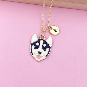 May include: Gold chain necklace with a black and white husky dog charm and a gold initial charm with the letter "A".