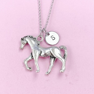May include: Silver horse charm necklace with a silver initial charm. The initial charm has the letter 'S' on it.