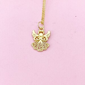 May include: A gold angel pendant necklace with a delicate, intricate design. The pendant is suspended from a thin gold chain.
