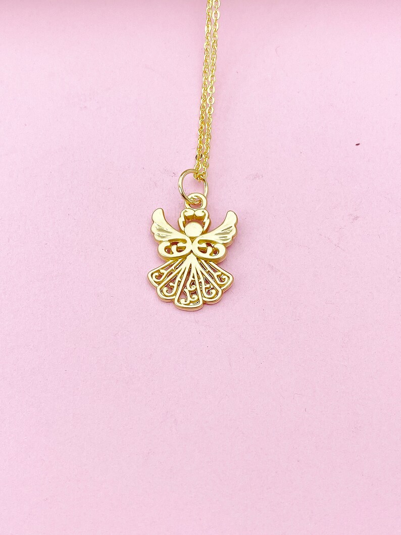 May include: A gold angel pendant necklace with a delicate, intricate design. The pendant is suspended from a thin gold chain.