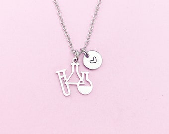 May include: A silver necklace with a charm of a beaker and test tube, and a small heart charm.
