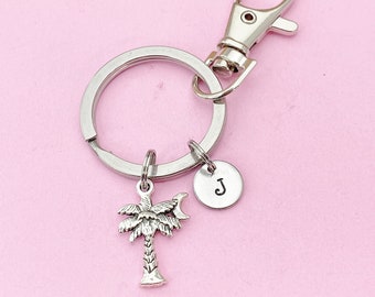 May include: Silver keychain with a palm tree charm and a round charm with the letter "J" on it.