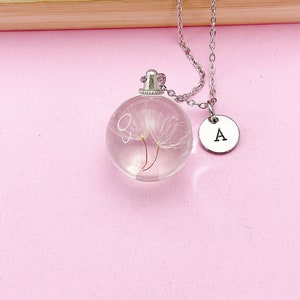 May include: A silver necklace with a clear glass orb pendant containing a dried dandelion and a silver charm with the letter 'A' hanging from it.