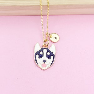 May include: Gold necklace with a black and white husky charm and a gold initial charm with the letter "A".
