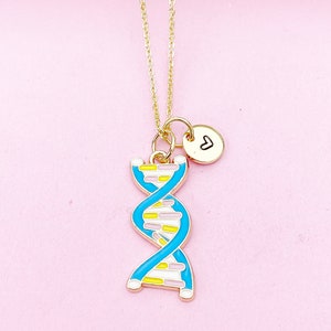 May include: A gold chain necklace with a blue and yellow DNA charm and a small gold circle charm with a heart engraved on it.