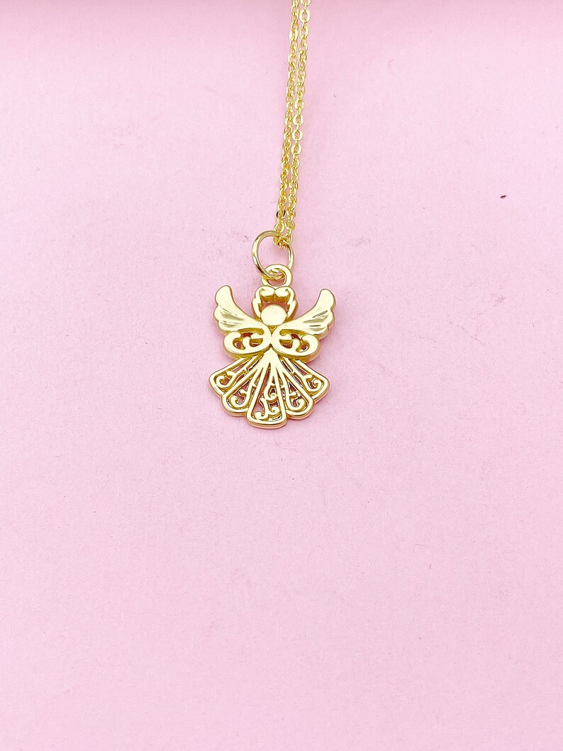 May include: A gold angel pendant necklace with a delicate, intricate design. The pendant features a detailed angel with wings and a halo. The necklace is on a thin gold chain.