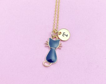 May include: A gold chain necklace with a black cat charm and a gold disc charm with the letter 'T' on it.