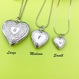 May include: Three silver heart-shaped lockets on chains, with the letters G, F, and W engraved on them. The lockets are labeled "Large", "Medium", and "Small" from left to right.