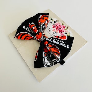 Cincinnati Bengals bow headband or hair clip; Bengals fabric bow on a black nylon headband or clip; NFL; baby, toddler, girl football bow