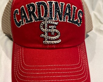 May include: Red and white baseball cap with a black and white "CARDINALS" logo and a rhinestone "St. Louis" logo.