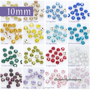 May include: Assortment of 10mm round rhinestones in various colours, including Jonquil, Colorado Topaz, Sapphire, Royal Blue, Topaz, Citrine, Aqua Blue, Peacock Blue, Dark Green, Olivinec, Light Siam, White Opal, Amethyst, Lilac, Light Pink, and Pink Opal.