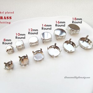 May include: A selection of nickel-plated brass round settings, ranging from 8mm to 18mm in diameter. The settings are arranged on a white surface, with size labels in millimetres.
