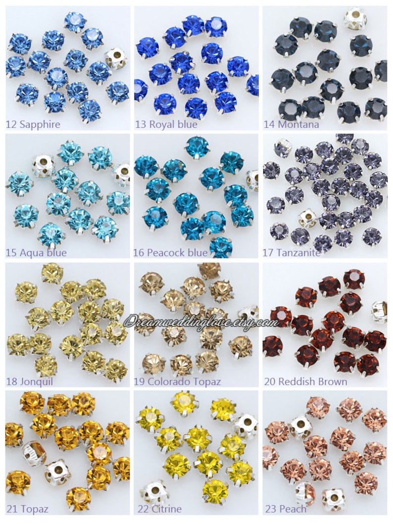 May include: Assortment of 23 colors of round, faceted, crystal rhinestones with silver settings. The rhinestones are arranged in rows of three, with each row representing a different color. The colors include sapphire, royal blue, montana, aqua blue, peacock blue, tanzanite, jonquil, colorado topaz, reddish brown, topaz, citrine, and peach.