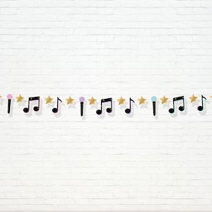 May include: A decorative banner featuring alternating musical notes, microphones, and gold stars. The musical notes are black with a light blue outline. The microphones are pink, purple, and teal. The banner is against a white brick wall.