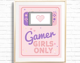 Può includere: Una stampa incorniciata rosa e viola con uno sfondo rosa e un'immagine pixelata di una console Nintendo Switch con un cuore rosa sullo schermo. Il testo "Gamer Girls Only" è scritto in lettere viola sotto l'immagine.