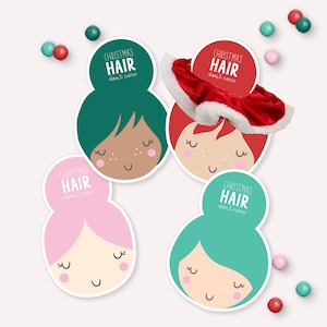 May include: Four colourful hair scrunchies with a cartoon face and the text "Christmas Hair don't care".